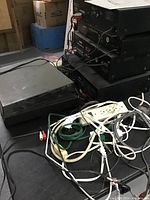 Photo of stacked Sony and Kenwood audio components, a turntable with dust cover, and multiple power and audio cables spread out on the table.