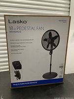 Photo of Lasko 18 inch pedestal fan in box showing product details and features