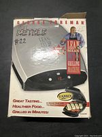 Box of George Foreman Lean Mean Fat Reducing Grilling Machine showing front panel, branding, and promotional text
