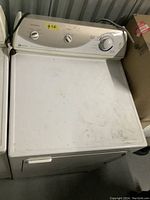 Front and top view of white Maytag gas dryer showing control knobs and overall condition.
