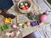 Overview of Easter decorations displaying bunnies, mini chairs, eggs, basket, and candy dish arranged on a table