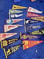Overview of all pennants laid out on blue carpet