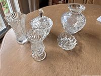 Set of clear glass mini vases, sugar dish with lid, and mini candy dish arranged on a table