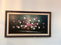 Framed oil painting of a bouquet of pink and white flowers in a brown vase on dark green background