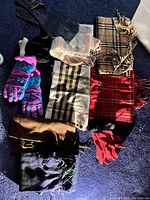 Six scarves, assorted patterns and colors, laid flat