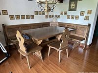 Front view of L-shaped corner bench with matching table and two chairs