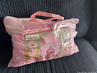 Photo of packed kids princess castle play tent bag with label showing product name and features.