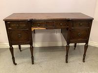 Full front view of antique wooden dresser showing overall condition and structure.