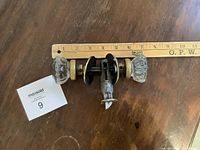 Pair of glass and metal doorknob assembly with measuring ruler showing length approximately 3.5 inches, including mounting hardware and connecting spindle.