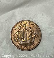 Reverse of the 1958 half penny coin showing a sailing ship with denomination and year.
