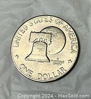 Reverse side of the coin showing the Liberty Bell and moon with text UNITED STATES OF AMERICA, ONE DOLLAR, and two stars.