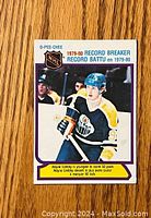 Front of vintage 1980-81 O-Pee-Chee Wayne Gretzky hockey card showing Wayne Gretzky in Edmonton Oilers jersey holding a hockey stick, with text noting his record-breaking 1979-80 season.