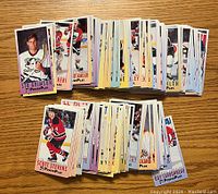 Photo of two large stacks of hockey cards from the 1993-94 Fleer Power Play series, showing player images and partial names.