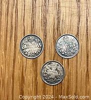 Photo showing reverse sides of three Canadian 5 cent silver nickels with dates 1905, 1916, and 1919. Featuring crown, maple leaves and denomination.