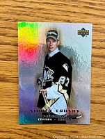 Front holographic side of Sidney Crosby rookie card with Penguins jersey and Upper Deck logo.