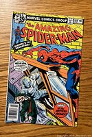 Front cover of The Amazing Spider-Man #189 with Spider-Man and mystery villain on window washing scaffold.