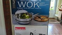 Front of box showing 3 piece wok set with steamer and lid, stainless steel and aluminum construction.