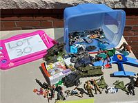 Wide view of the lot showing action figures, vehicles, toys, and packaging box.