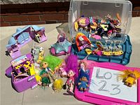 Full collection of Trolls figures, playsets, and accessories shown on a surface outdoors.