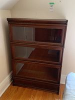 Full front view of bookcase showing three glass-front sections