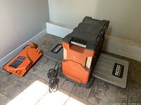 Planer with side tables extended and power cord coiled at base