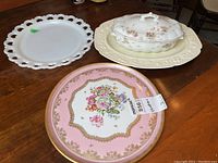 Three platters: pink floral Birks platter, white pierced-edge platter, ivory embossed platter with Doulton Burslem covered serving dish on top