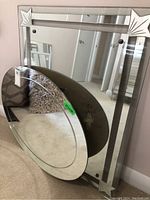 Two mirrors leaning against a wall, showing dimensions and overall condition with wear.