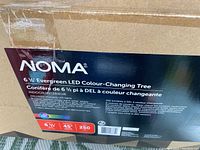 Box label showing Noma brand, 6.5 foot (6 1/2 ft) prelit RGB LED Christmas tree with 250 colour-changing lights and 45 inch diameter.