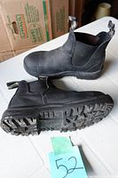 Side and sole view of one black Blundstone steel toe boot, showing tread pattern and condition with minimal dirt and wear.