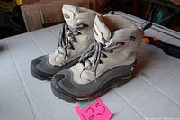 Pair of Columbia waterproof boots on a table, showing overall shape, laces, and condition.