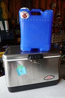 Cooler and water jug together showing size and condition