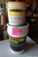Front and stacked view of the 2 Gallon Min-O-Life bucket on top of the 6 Gallon Sit-N-Fish bucket showing brand and model names
