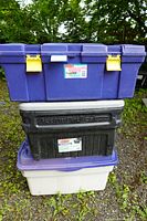 Set of three Rubbermaid storage totes stacked: purple 70L Rough Tote on top, black 90.8L ActionPacker in middle, grayish 140L Rough Tote at bottom