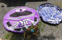 Both Inflatable tubes and coiled tow rope laid out on gravel