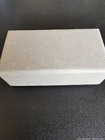 Closed rectangular box with textured surface and neutral color