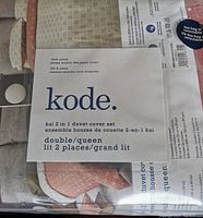 Photo showing the packaging label with brand name Kode, set description as Kai 2-in-1 duvet cover set for double/queen size.
