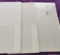 Three folded white Ikea storage cubes laid flat, showing the DRONAS label.