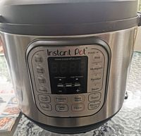 Front view of Instant Pot Duo model with control panel and buttons visible.