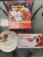 Food slicer box and two vintage plates along with boxed porcelain teapot