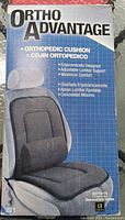 Box front showing picture of orthopedic cushion on a car seat with ergonomic design and adjustable lumbar support, charcoal color.