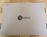 Closed cardboard box with Lefant logo indicating the brand of the robot vacuum.