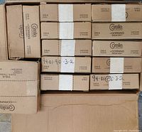 Packed Corelle boxes in cardboard container showing brand and product info with 'contains 4 pieces' labels