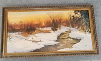 Full front view of the vintage framed oil painting showing winter landscape with snow, stream, trees and sunset.
