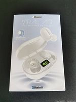 Front of the 2Boom Viral Air earphones box showing white earbuds and charging case with LED battery display, Bluetooth and Google Assistant compatible logos visible.