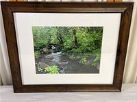 Framed landscape photographic print showing a clear view of the stream and surrounding foliage in the matting