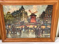 Framed print of Moulin Rouge and cityscape signed by Antoine Blanchard.