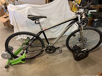 Full side view of Specialized bike mounted on Kinetic trainer with front tire stand