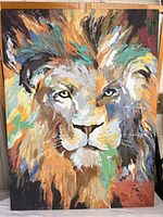 Frontal photo showing the entire lion's face print with vibrant embellishments and colors.