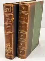 Two antique books side by side: one titled 'The Italian Lakes' and the other 'Paris'. Both have leather spines with gold embossing and have wear consistent with age.