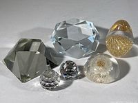 Full lot view showing all five crystal pieces and one acrylic dome with dandelion seed cluster.